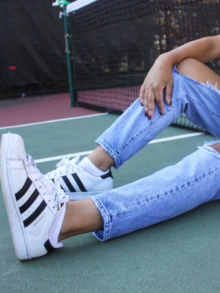 Deanna London is wearing adidas "adidas Women's Superstar Casual Sneakers from Finish Line"