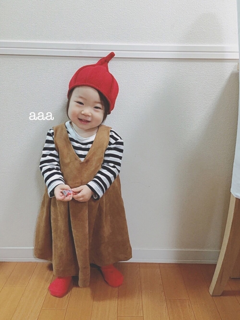 「女の子、1歳、ボーダー、ワンピース、キャメル、タイツ、赤タイツ、トンガリ帽子、ちびボーダー族」｜「petit mainのスエードジャンパースカート（ジャンパースカート、イエロー系）」を使った、soo&aaaさん（キッズ・70cm）の冬コーディネートの1枚目の写真