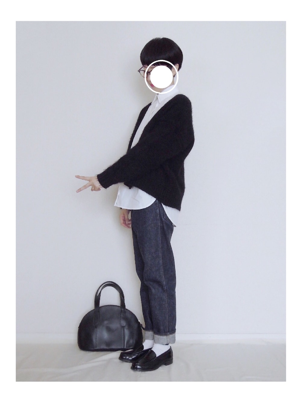 ブルー系のデニムパンツ、ブラック系のボストンバッグを着用したレディースの秋コーディネートの1枚目の写真