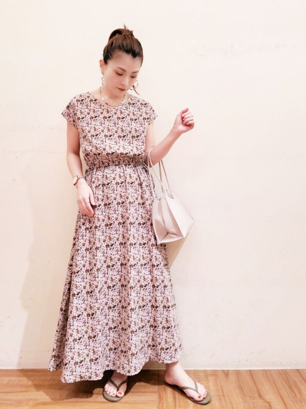 グレー系のトートバッグ、ブラウン系のワンピースを着用したレディースの夏コーディネートの1枚目の写真