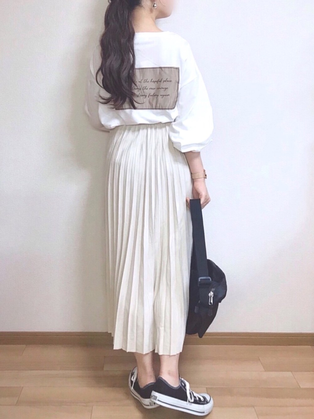 ホワイト系のTシャツ/カットソー、ベージュ系のスカート、ブラック系のショルダーバッグを着用したレディースの秋コーディネートの1枚目の写真