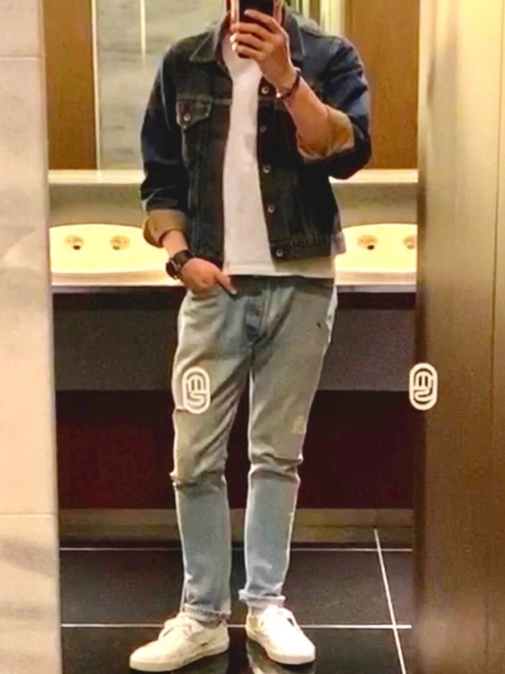 ブルー系のデニムパンツ、ブルー系のデニムジャケット、ホワイト系のスニーカーを着用したメンズの秋コーディネートの1枚目の写真