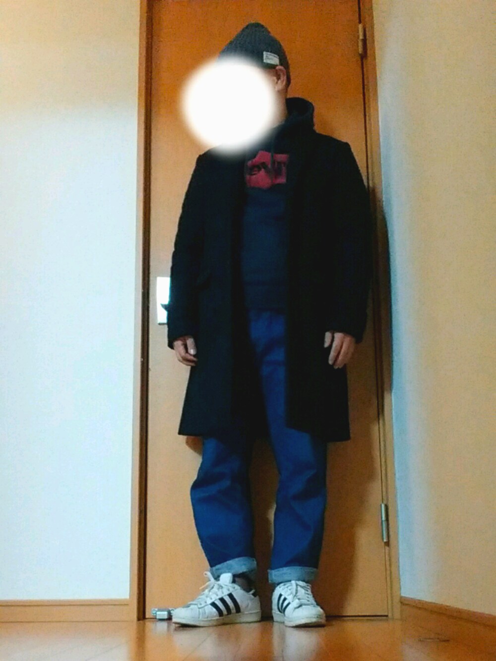 ブルー系のチェスターコート、ブルー系のパーカー、ブルー系のデニムパンツを着用したメンズの冬コーディネートの1枚目の写真