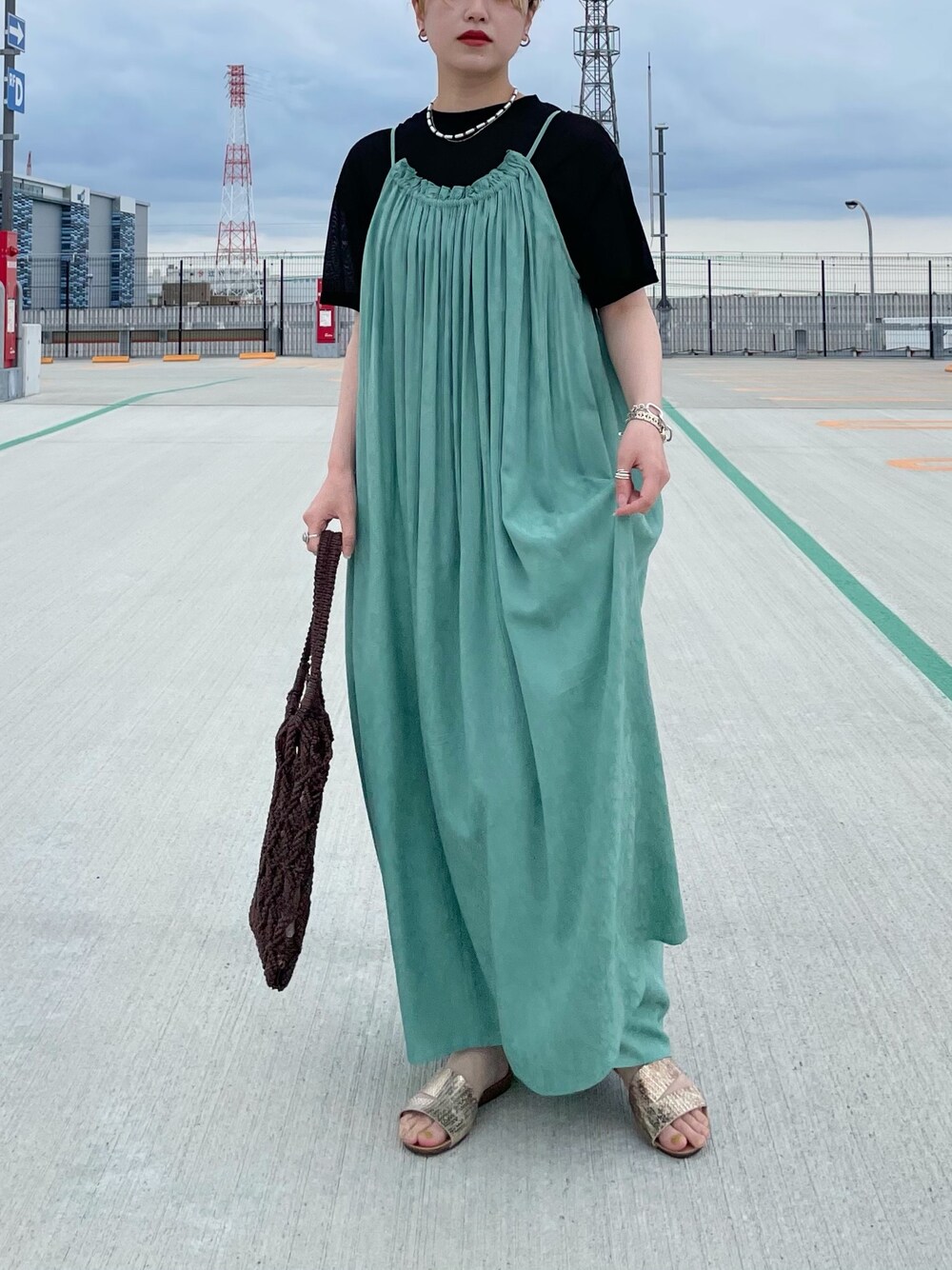 ブラック系のTシャツ/カットソー、グリーン系のワンピース、ブラウン系のトートバッグを着用したレディースの夏コーディネートの1枚目の写真