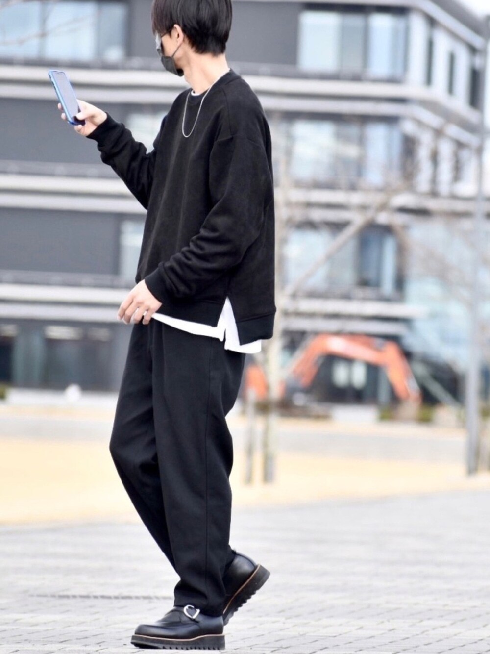 ブラック系のスウェット、ホワイト系のTシャツ/カットソー、ブラック系のスラックスを着用したメンズの春コーディネートの1枚目の写真