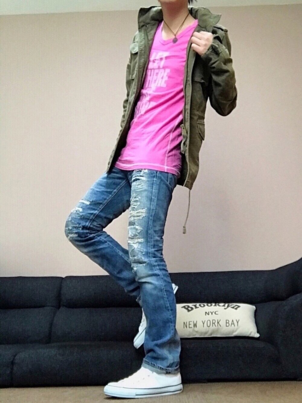 グリーン系のミリタリージャケット、ピンク系のTシャツ/カットソー、ブルー系のデニムパンツを着用したメンズの春コーディネートの1枚目の写真