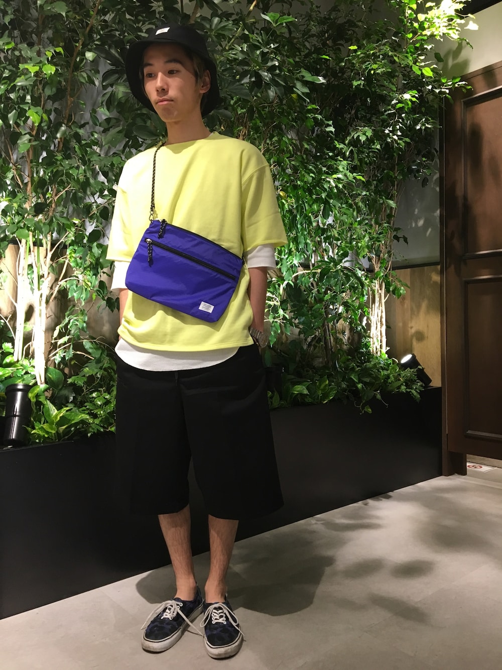 イエロー系のTシャツ/カットソー、ホワイト系のTシャツ/カットソー、ブルー系のショルダーバッグを着用したメンズの春コーディネートの1枚目の写真