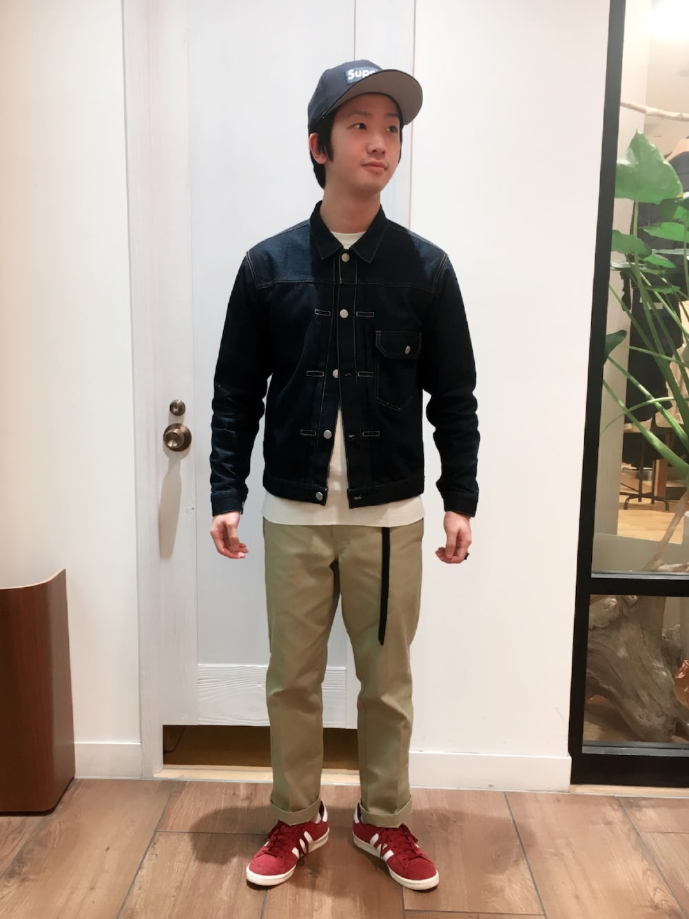 ブルー系のデニムジャケット、ホワイト系のTシャツ/カットソー、ベージュ系のチノパンツを着用したメンズの春コーディネートの1枚目の写真