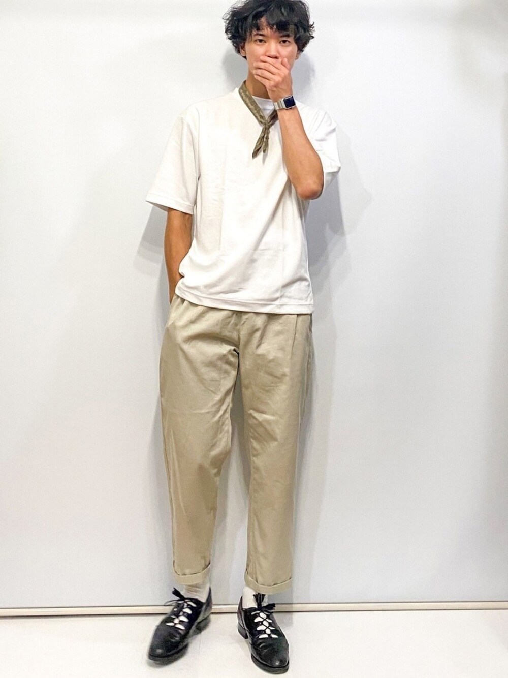 ベージュ系のパンツ、ホワイト系のTシャツ/カットソー、グリーン系のバンダナ/スカーフを着用したメンズの夏コーディネートの1枚目の写真