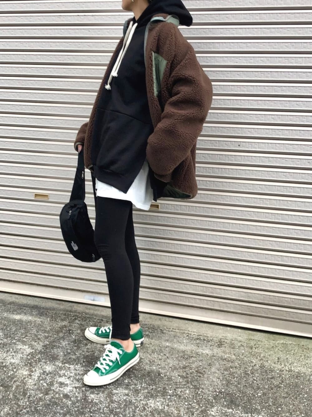 ブラウン系のジャケット/アウター、ブラック系のパーカー、ブラック系のボディバッグ/ウエストポーチを着用したレディースの冬コーディネートの1枚目の写真