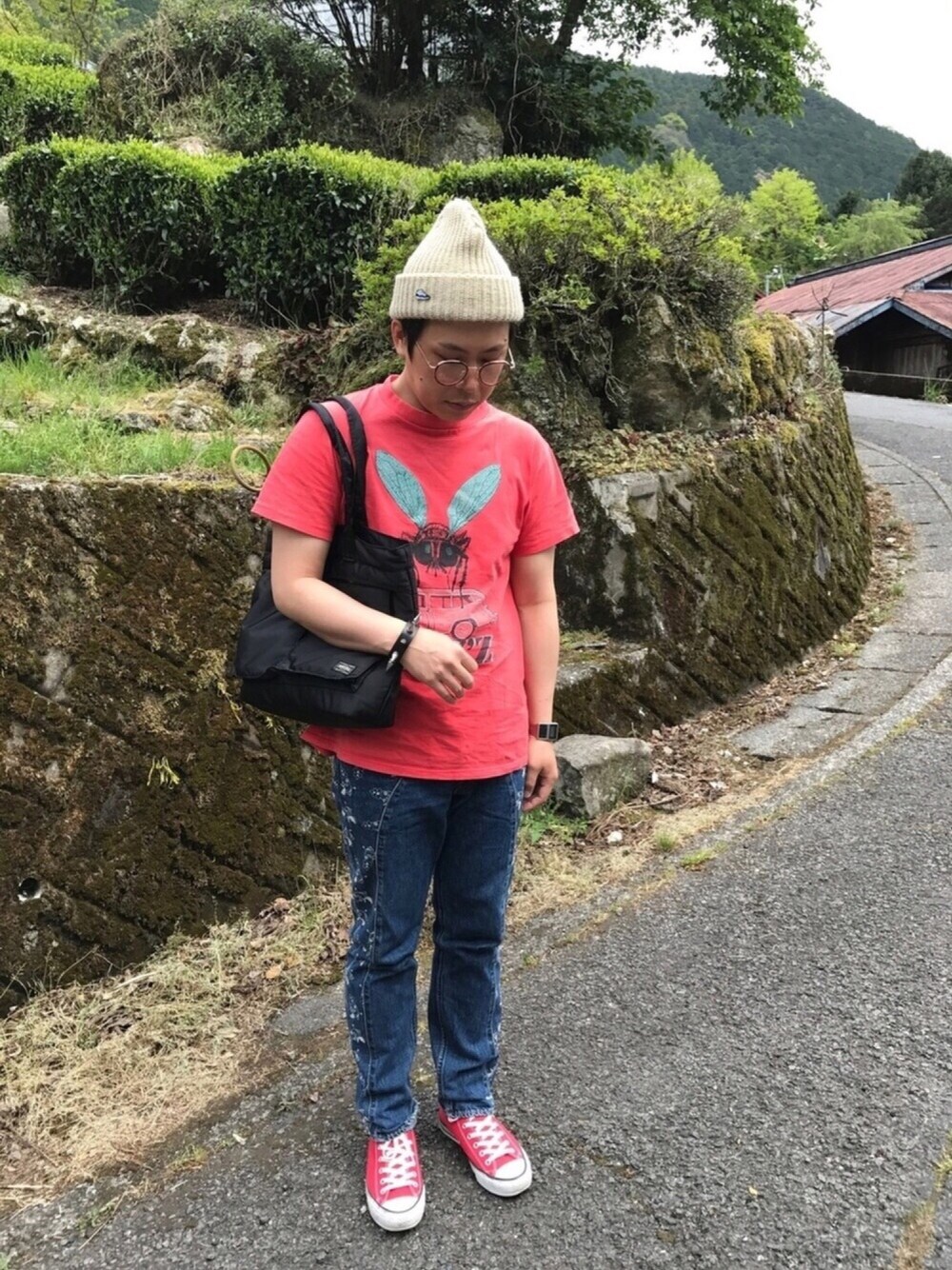 レッド系のTシャツ/カットソー、ブルー系のデニムパンツ、レッド系のスニーカーを着用したメンズの春コーディネートの1枚目の写真