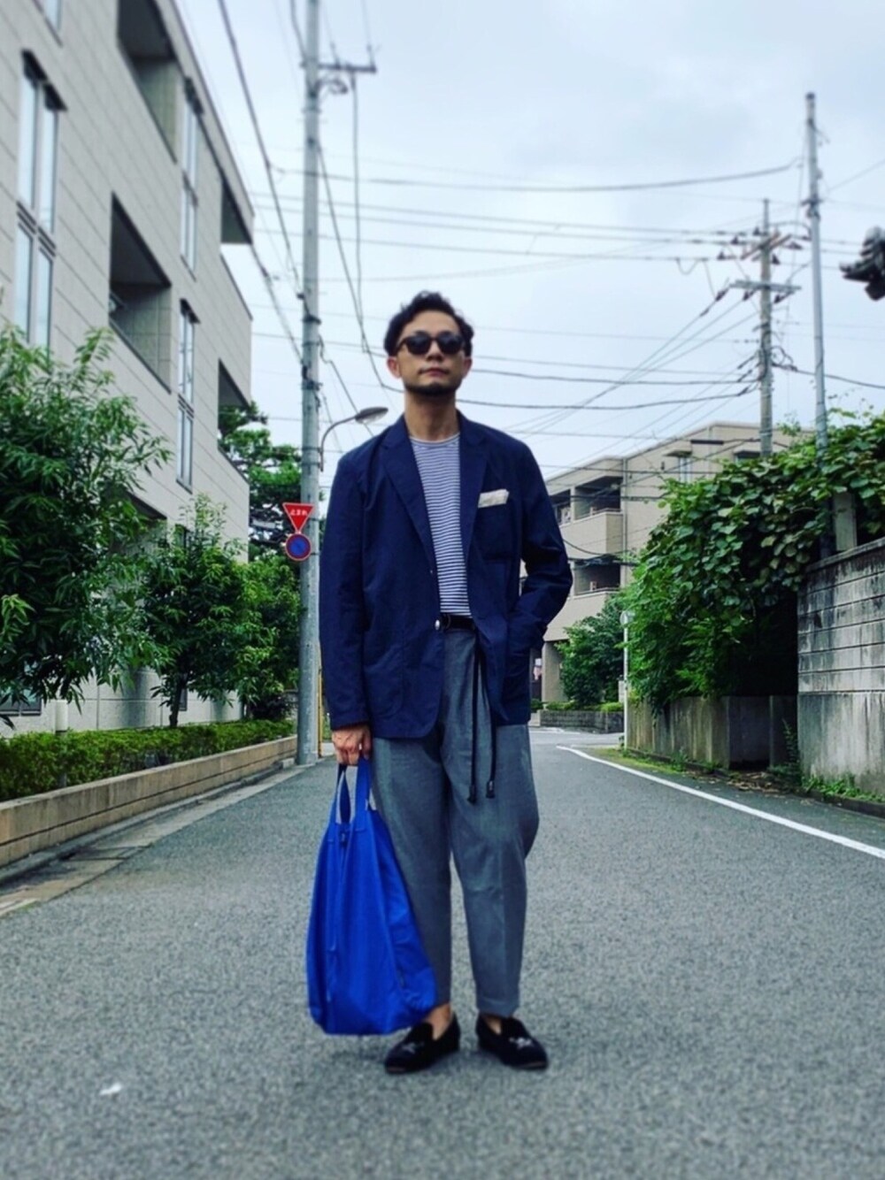 ホワイト系のTシャツ/カットソー、ブルー系のその他アウター、グレー系のスラックスを着用したメンズの夏コーディネートの1枚目の写真