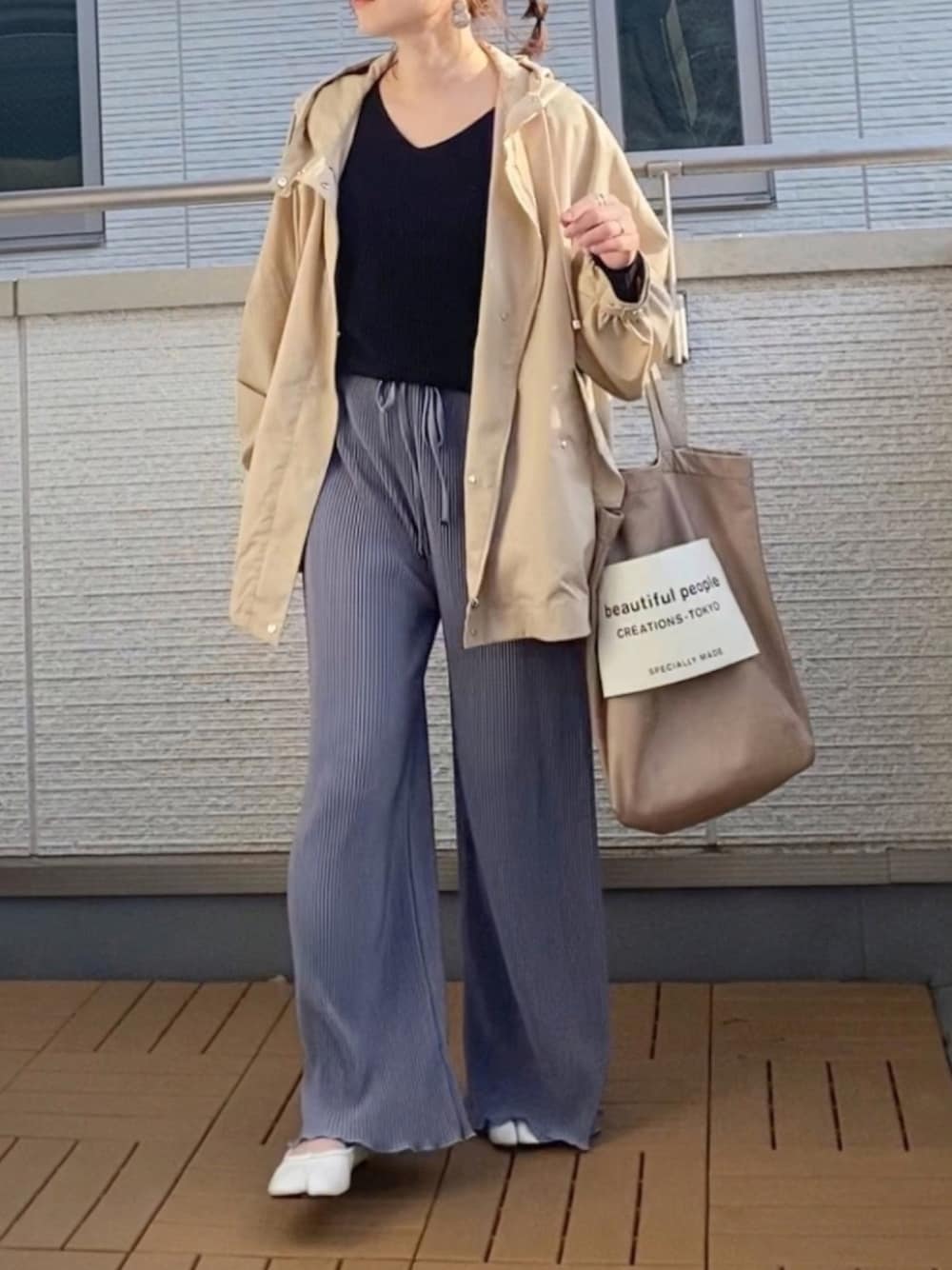 ベージュ系のブルゾン、ブラック系のニット/セーター、ブルー系のその他パンツを着用したレディースの春コーディネートの1枚目の写真