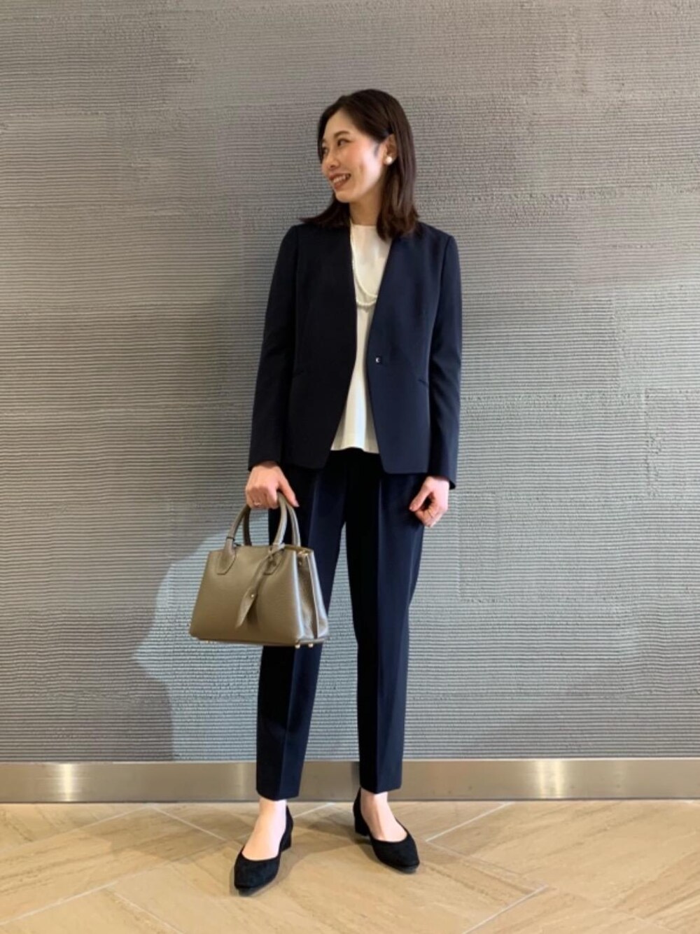 ブラック系のパンプス、ブルー系のその他パンツ、ホワイト系のシャツ/ブラウスを着用したレディースの冬コーディネートの1枚目の写真