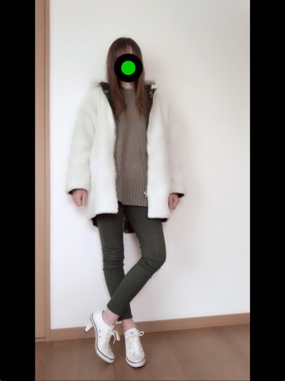 ホワイト系のその他アウター、グリーン系のニット/セーター、ホワイト系のパンプスを着用したレディースの冬コーディネートの1枚目の写真