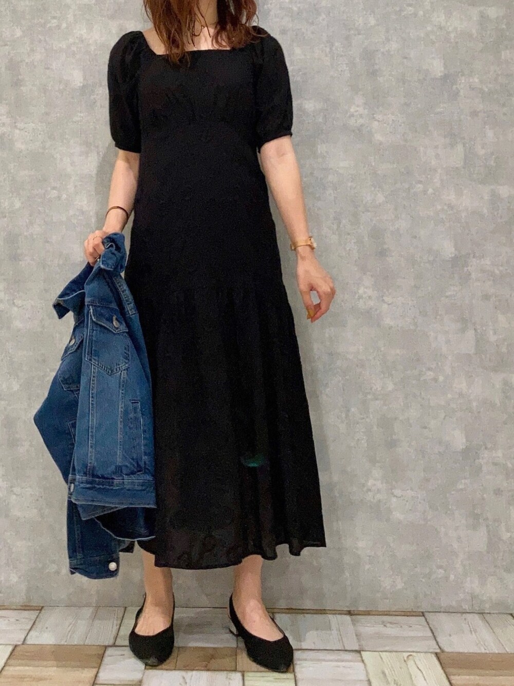 ブラック系のワンピースを着用したレディースの秋コーディネートの1枚目の写真