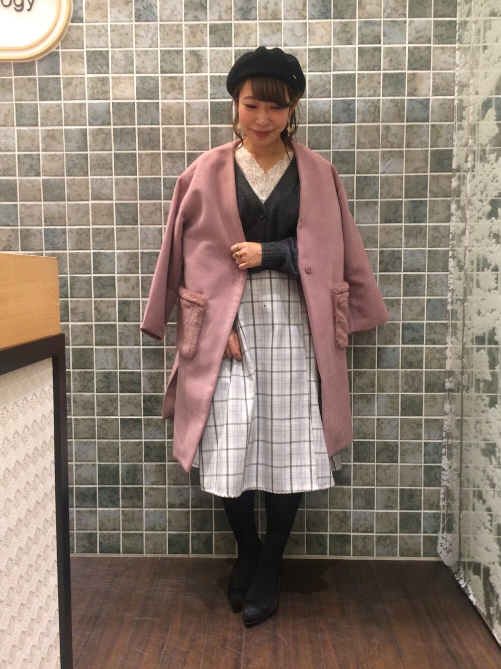 ホワイト系のスカート、グレー系のカーディガン/ボレロ、ピンク系のノーカラージャケットを着用したレディースの冬コーディネートの1枚目の写真