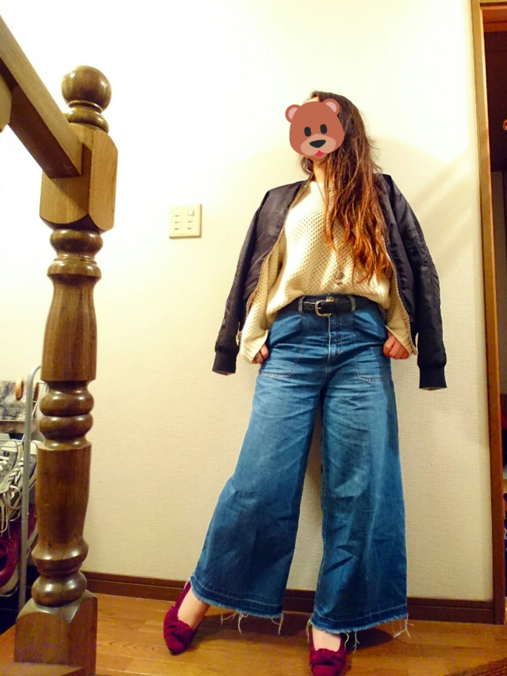 ホワイト系のニット/セーター、ブルー系のデニムパンツ、ブラック系のジャケット/アウターを着用したレディースの冬コーディネートの1枚目の写真