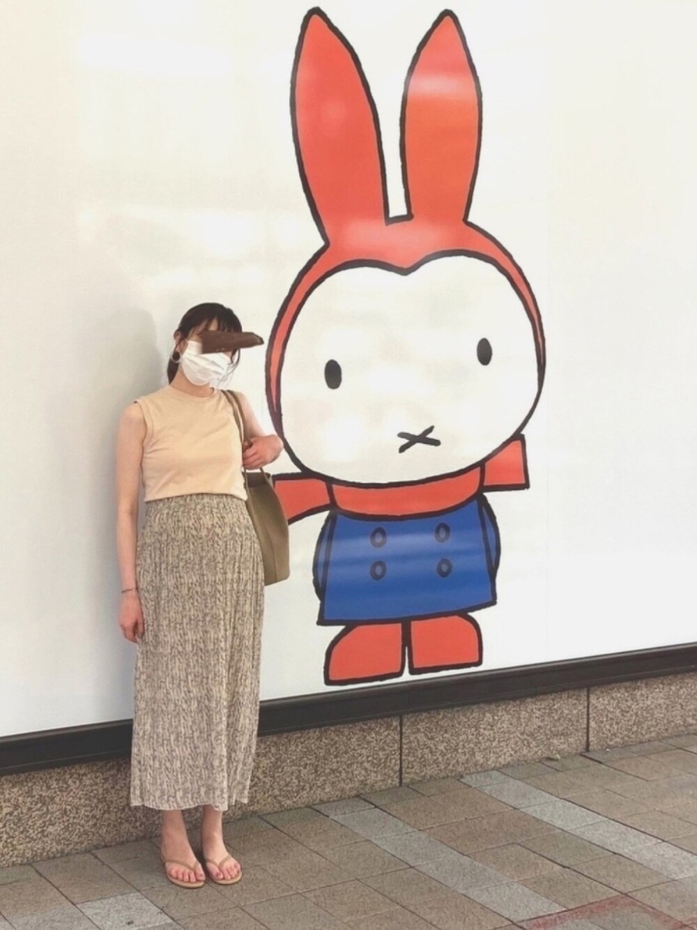 ベージュ系のTシャツ/カットソー、ベージュ系のビーチサンダル、ブラウン系のショルダーバッグを着用したレディースの夏コーディネートの1枚目の写真