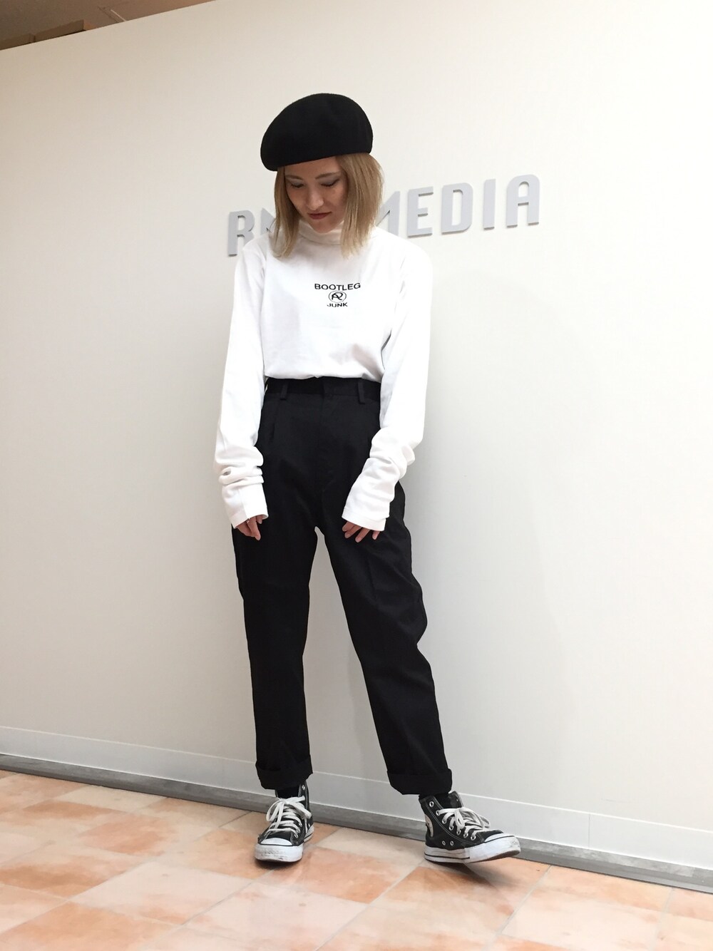 ホワイト系のTシャツ/カットソー、ブラック系のチノパンツを着用したレディースの秋コーディネートの1枚目の写真