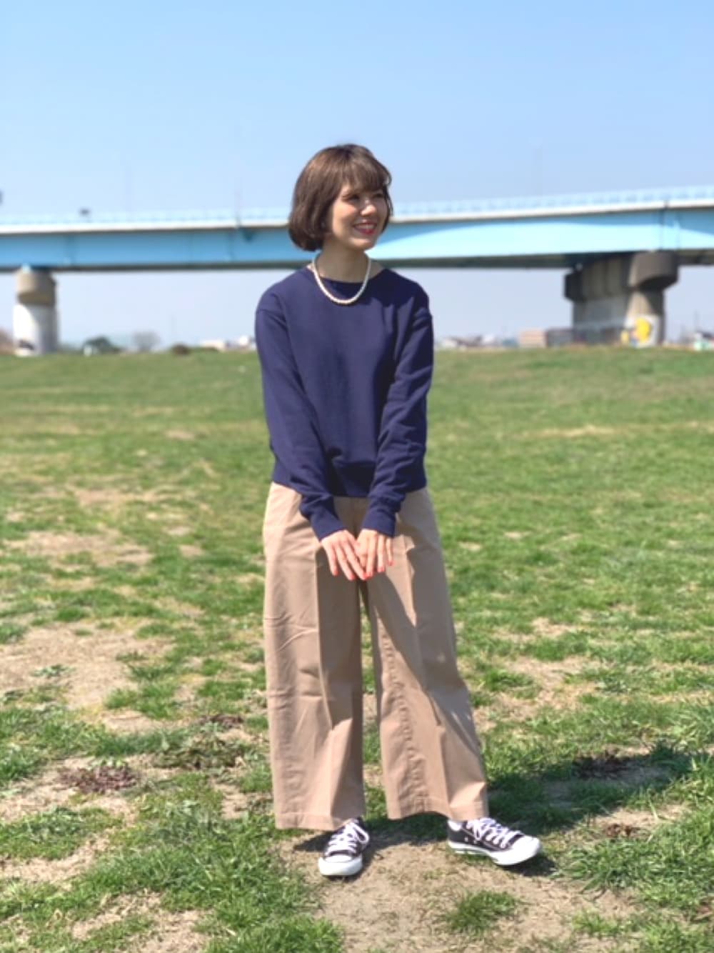 ブルー系のTシャツ/カットソー、ブラック系のスニーカー、ベージュ系のその他パンツを着用したレディースの春コーディネートの1枚目の写真