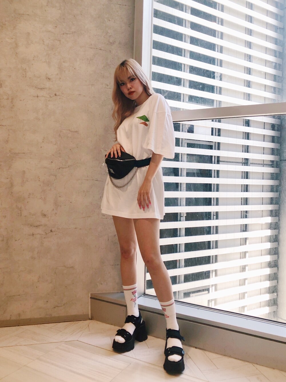 ホワイト系のTシャツ/カットソー、ブラック系のボディバッグ/ウエストポーチ、ブラック系のサンダルを着用したレディースの夏コーディネートの1枚目の写真