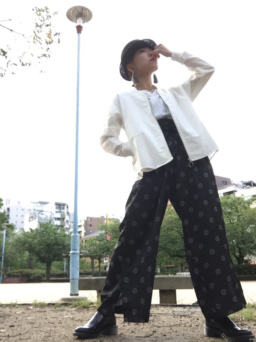 ホワイト系のブルゾン、ブラック系のその他パンツ、ブラック系のドレスシューズを着用したレディースの春コーディネートの1枚目の写真