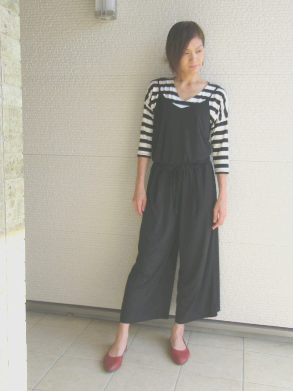 レッド系のパンプス、ホワイト系のTシャツ/カットソーを着用したレディースの春コーディネートの1枚目の写真