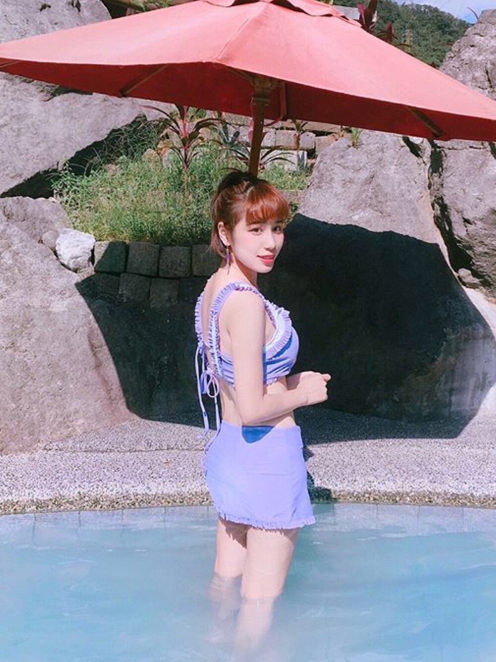 パープル系の水着を着用したレディースの春コーディネートの1枚目の写真