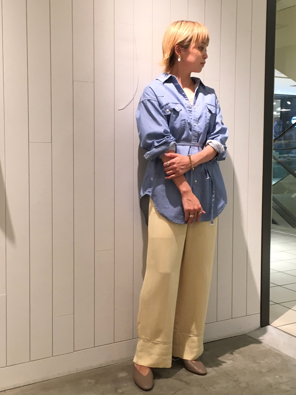 ブルー系のシャツ/ブラウス、イエロー系のその他パンツ、ベージュ系のシューズを着用したレディースの春コーディネートの1枚目の写真