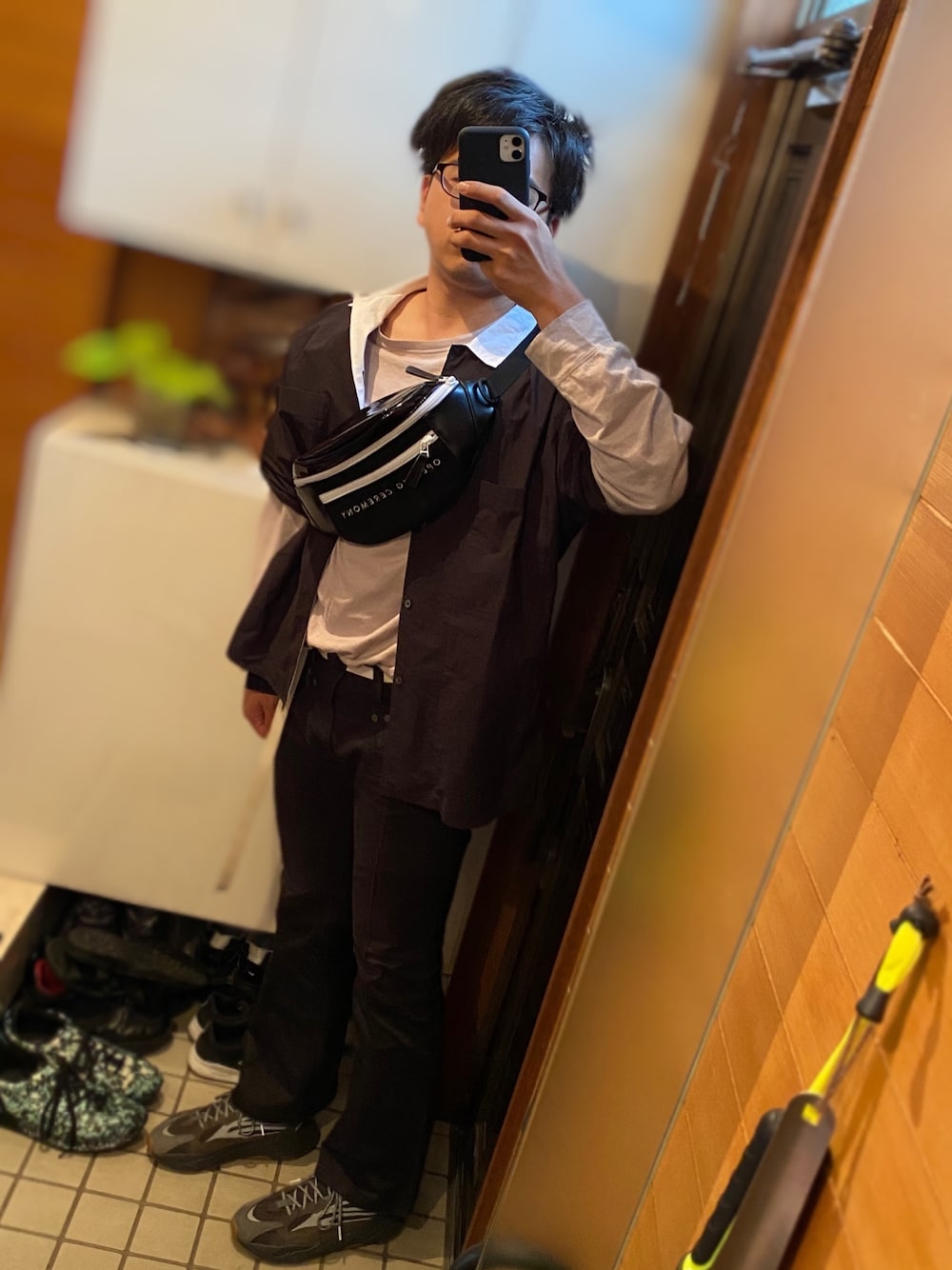 ブラック系のシャツ/ブラウス、ブラック系のボディバッグ/ウエストポーチ、グレー系のTシャツ/カットソーを着用したメンズの夏コーディネートの1枚目の写真