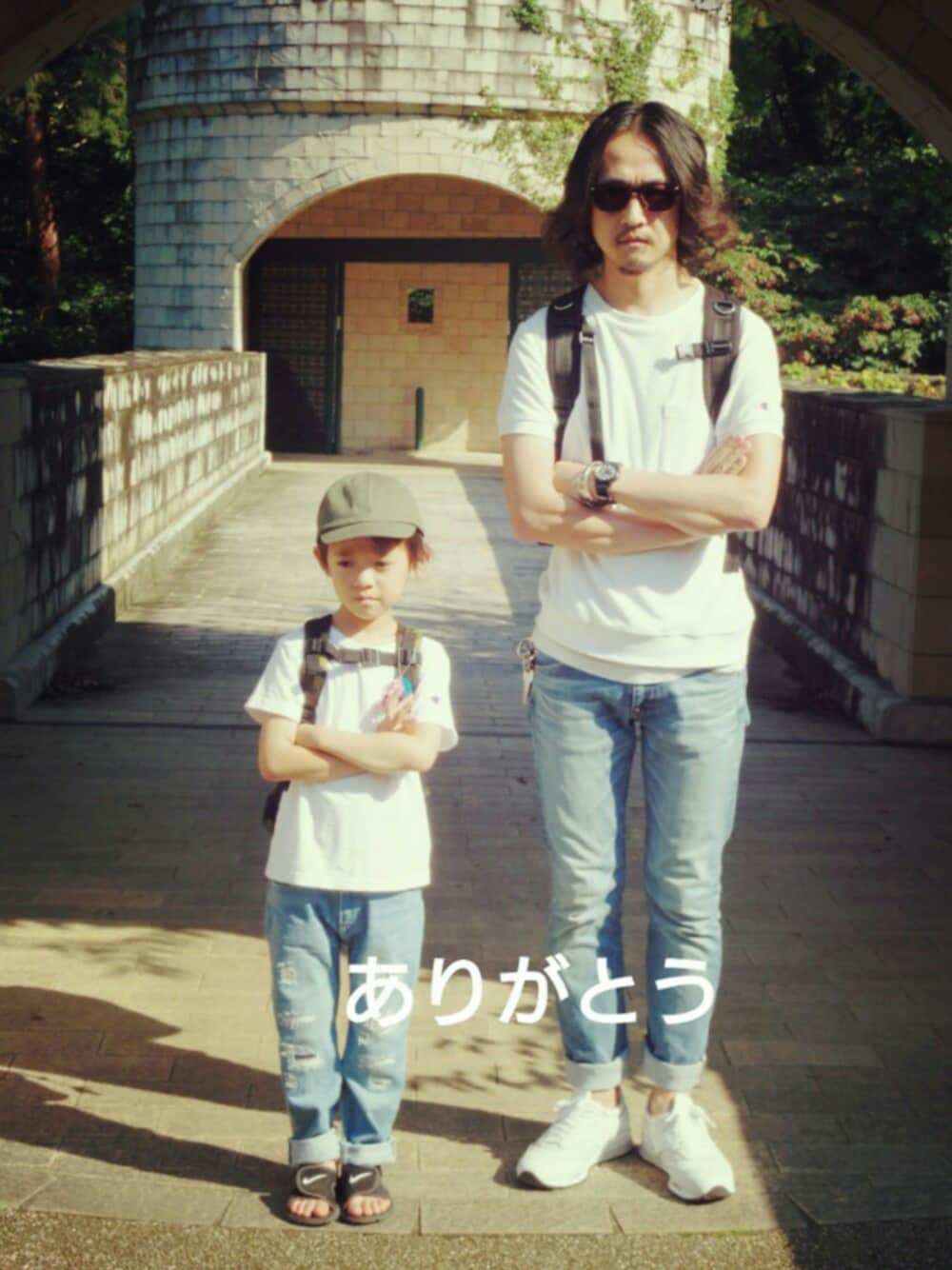 ブルー系のデニムパンツ、ホワイト系のTシャツ/カットソー、ブラック系のサンダルを着用したメンズの秋コーディネートの1枚目の写真