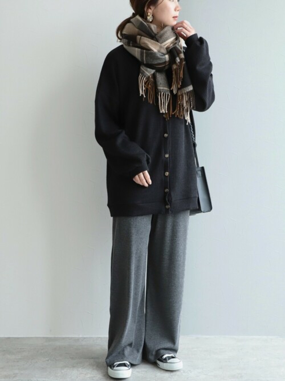 ブラック系のカーディガン/ボレロ、ベージュ系のストール/ショールを着用したレディースの冬コーディネートの1枚目の写真