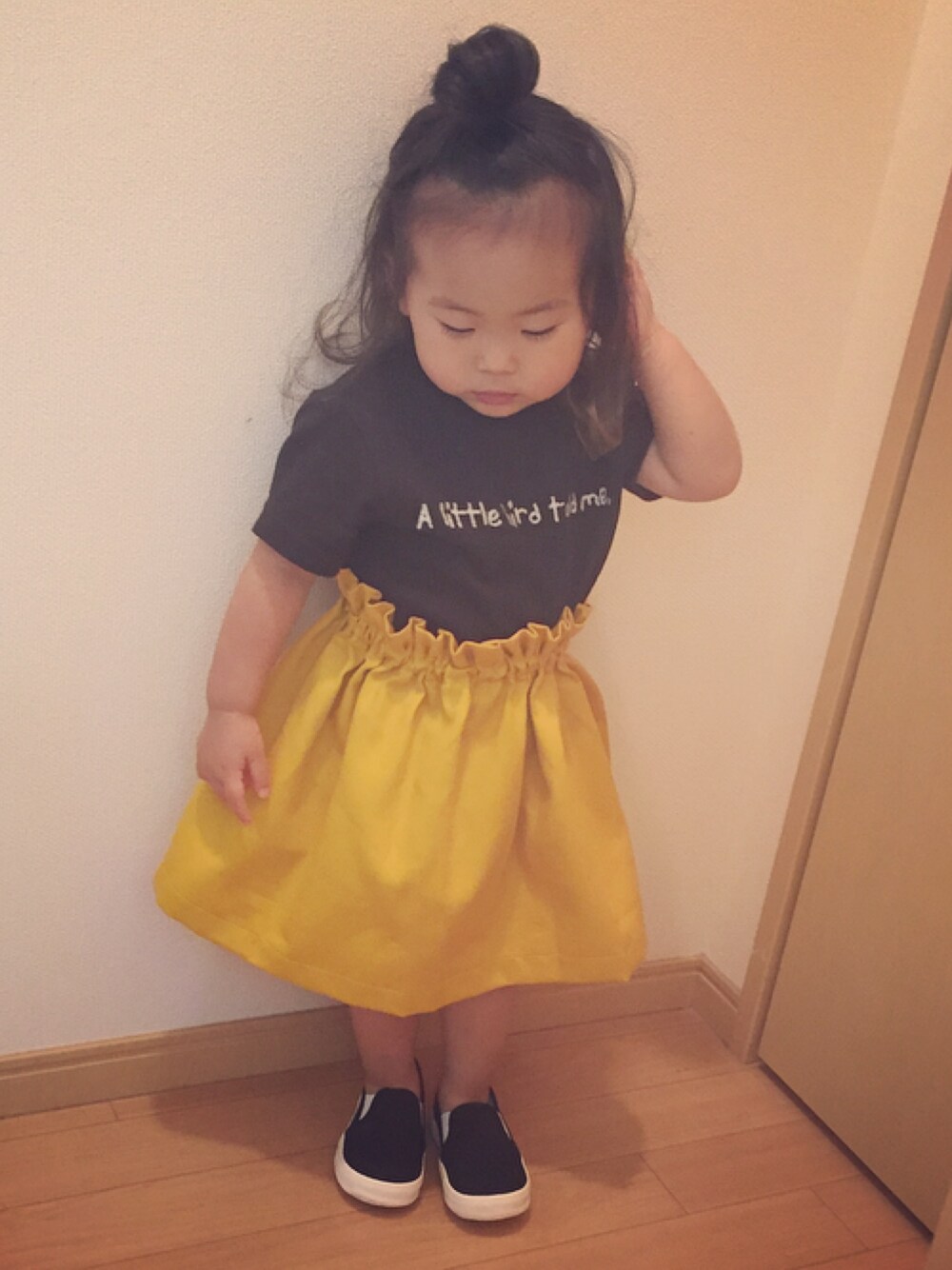 「イエロー、イエロー×ブラック、スカート、黒Tシャツ、インスタイル、マスタード、スリッポン、キッズコーデ、おだんごヘアー、カジュアル」｜「Birthdayのアイテム（Tシャツ/カットソー、ブラック系）」を使った、epiさん（キッズ・90cm）の夏コーディネートの1枚目の写真