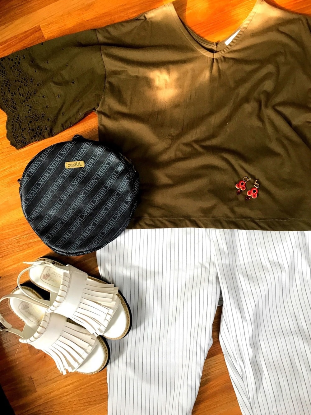 グリーン系のTシャツ/カットソー、ホワイト系のパンツ、ホワイト系のサンダルを着用したレディースの夏コーディネートの1枚目の写真