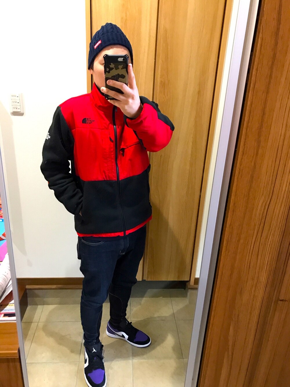 レッド系のブルゾン、ブルー系のスウェット、グレー系のタンクトップを着用したメンズの冬コーディネートの1枚目の写真