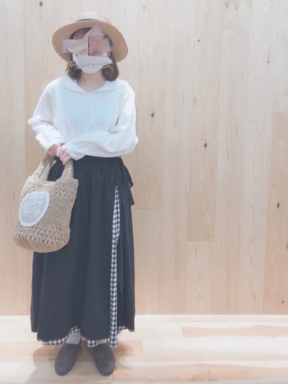 ホワイト系のシャツ/ブラウス、ブラック系のスカート、ベージュ系のトートバッグを着用したレディースの春コーディネートの1枚目の写真