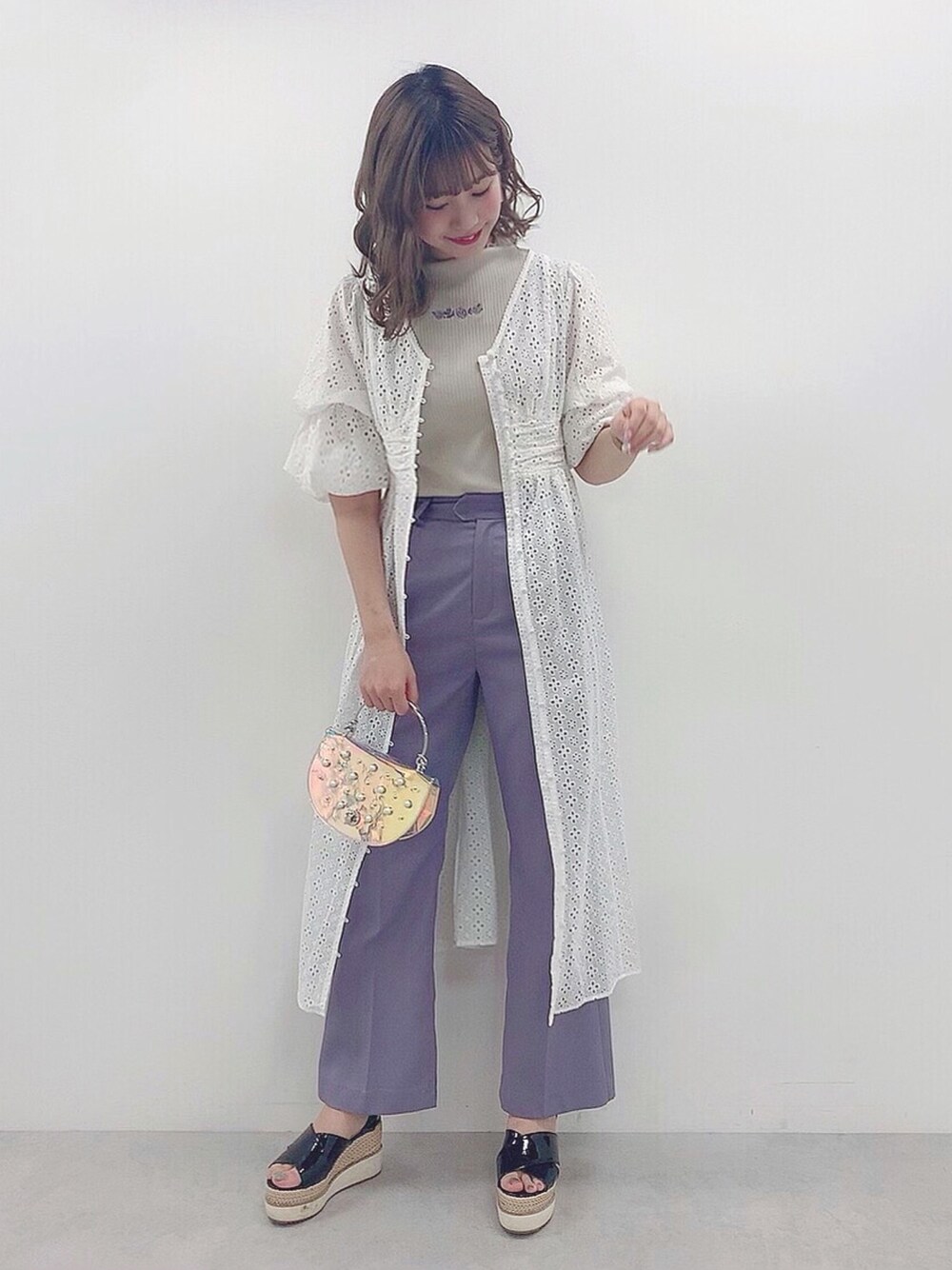 ホワイト系のタンクトップ、その他のショルダーバッグ、パープル系のスラックスを着用したレディースの春コーディネートの1枚目の写真