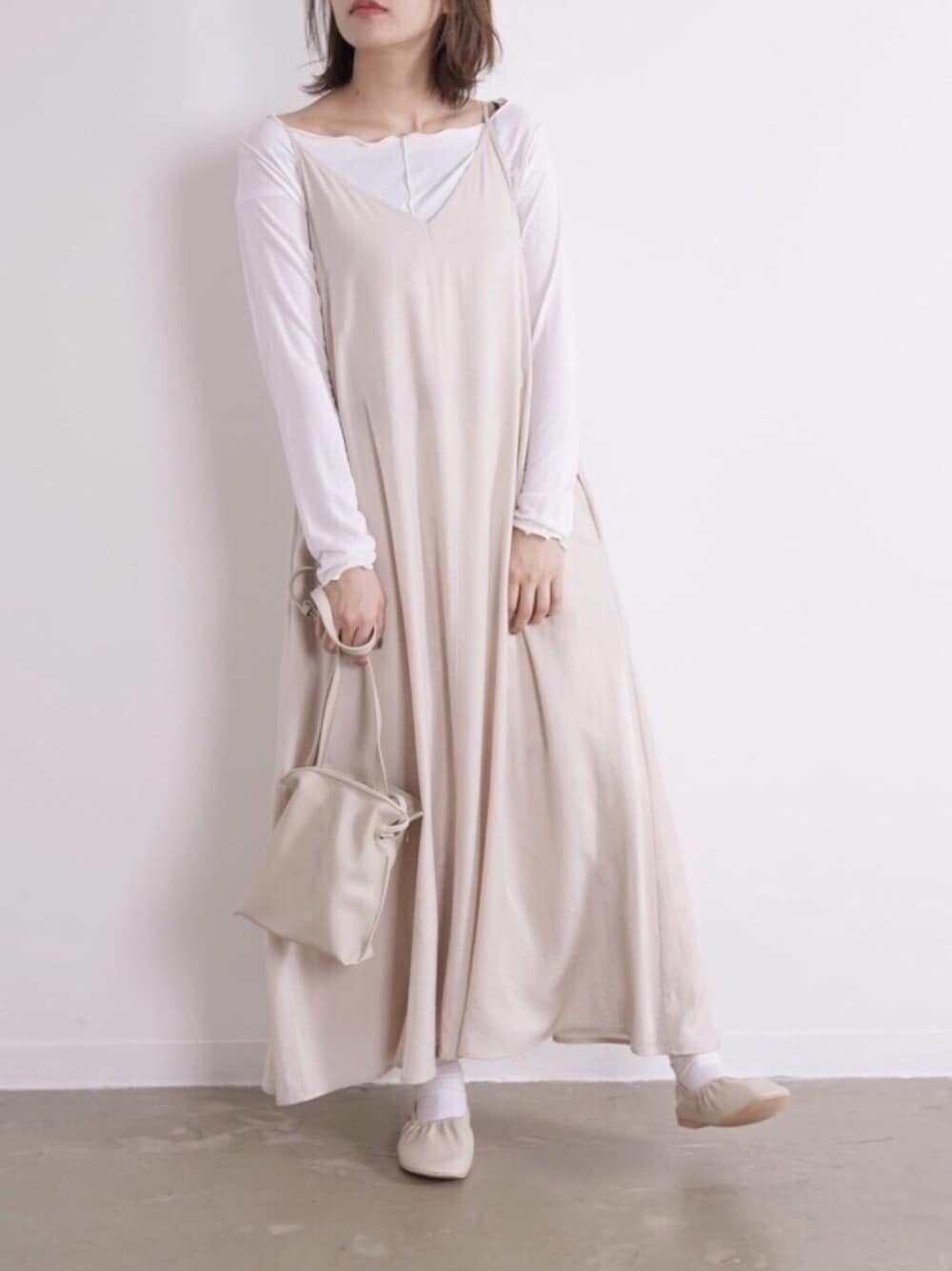 ホワイト系のワンピース、ホワイト系のニット/セーター、ホワイト系のパンプスを着用したレディースの春コーディネートの1枚目の写真