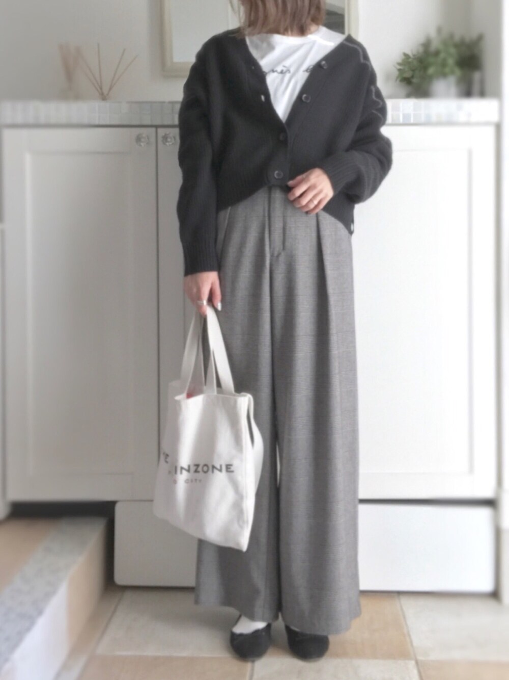 ブラック系のカーディガン/ボレロ、グレー系のパンツ、ブラック系のバレエシューズを着用したレディースの秋コーディネートの1枚目の写真