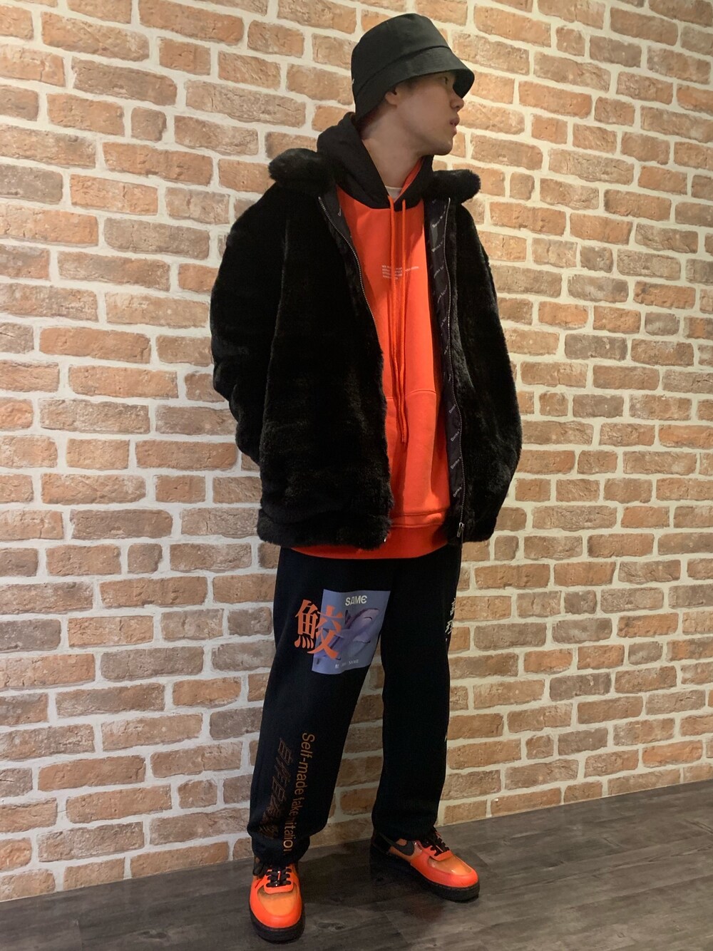 「スウェットパンツ、スニーカー、LHP、オレンジ、Danke schon、ファーブルゾン、バケットハット、ナイロンパーカー、フーディー、漢字」｜「DANKE SCHONのアイテム（パーカー、オレンジ系）」を使った、山田 統生さん（メンズ・182cm）の秋コーディネートの1枚目の写真