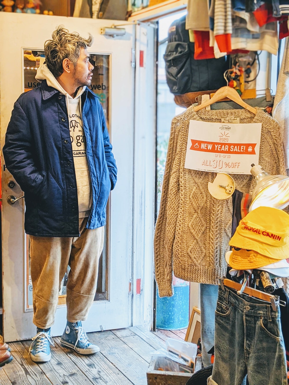 ブルー系のカバーオール、グレー系のパーカー、ベージュ系のパンツを着用したメンズの冬コーディネートの1枚目の写真