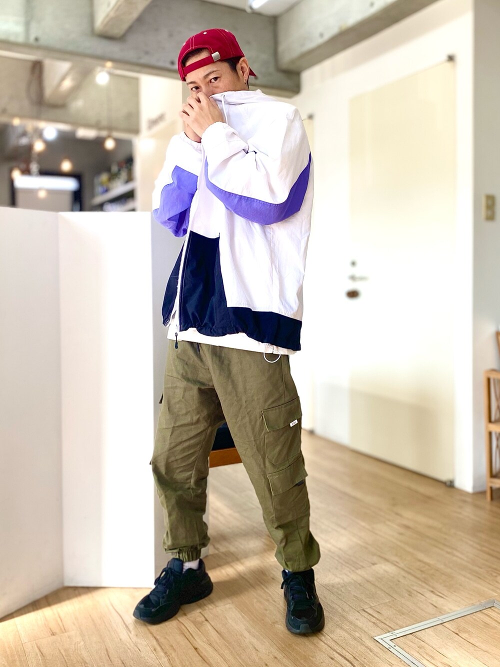 ホワイト系のナイロンジャケット、グリーン系のカーゴパンツ、ホワイト系のTシャツ/カットソーを着用したメンズの春コーディネートの1枚目の写真