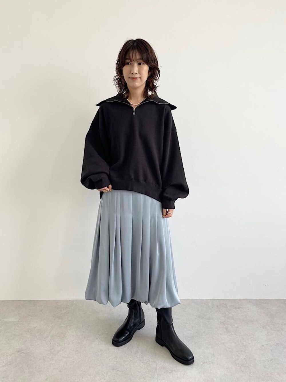 ブルー系のスカート、グレー系のスウェット、ホワイト系のネックレスを着用したレディースの夏コーディネートの1枚目の写真