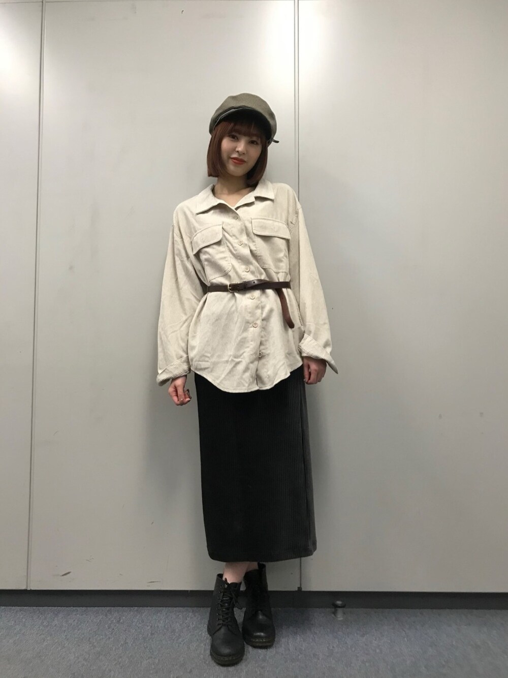 グレー系のスカート、ブラウン系の帽子を着用したレディースの秋コーディネートの1枚目の写真