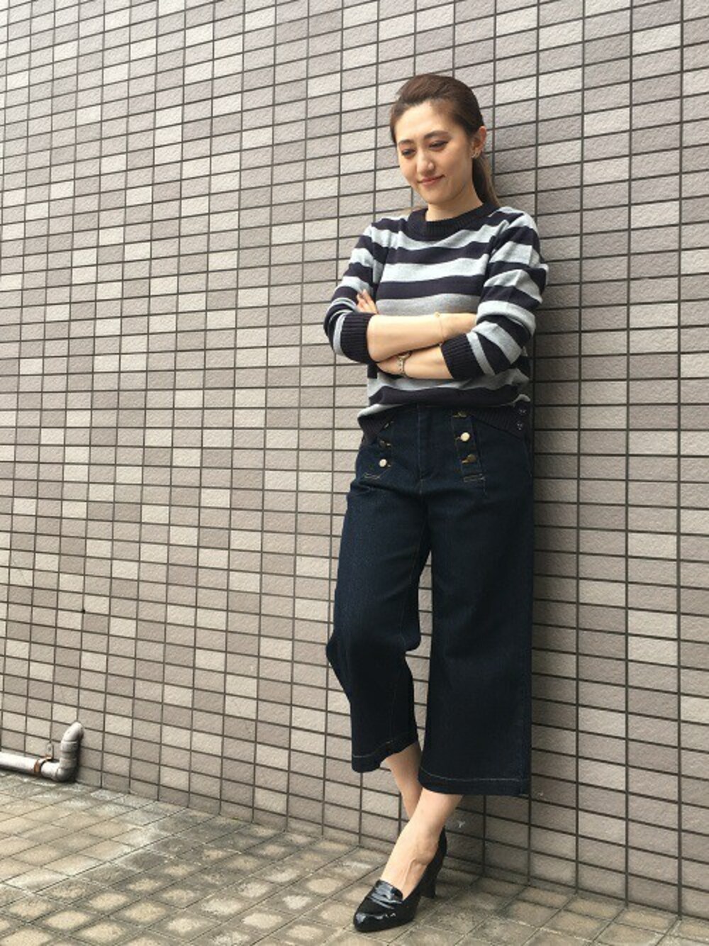 ブルー系のデニムパンツ、ブルー系のニット/セーターを着用したレディースの秋コーディネートの1枚目の写真