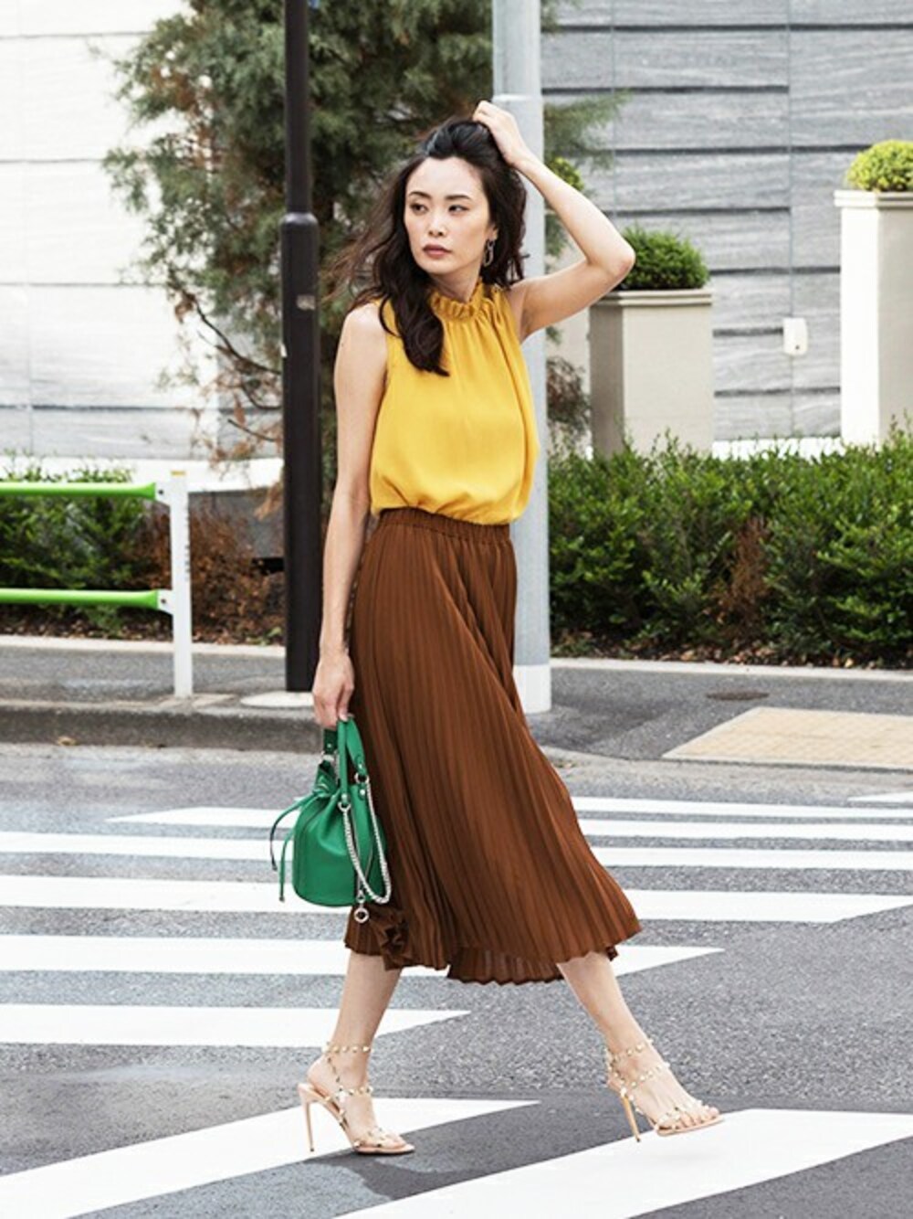 ブラウン系のスカート、イエロー系のシャツ/ブラウスを着用したレディースの夏コーディネートの1枚目の写真