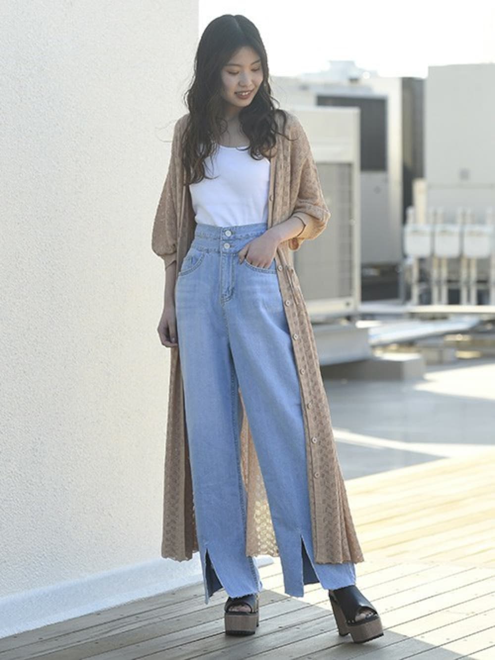 ブルー系のデニムパンツ、ホワイト系のキャミソール、ブラック系のサンダルを着用したレディースの春コーディネートの1枚目の写真