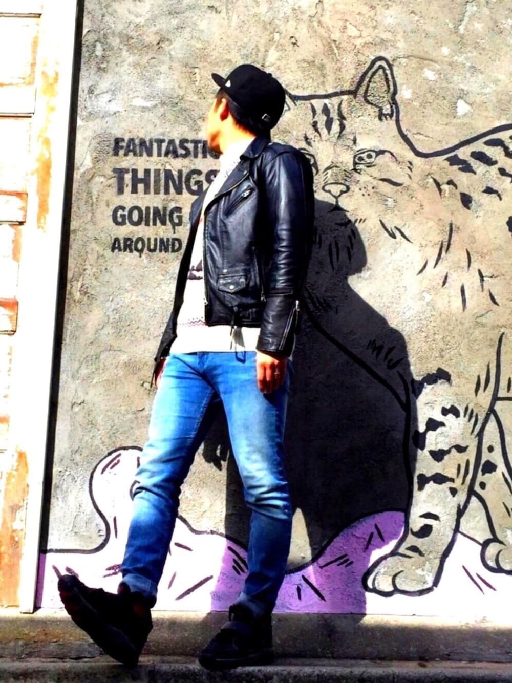 ブルー系のデニムパンツ、ブラック系のスニーカー、ブラック系のライダースジャケットを着用したメンズの冬コーディネートの1枚目の写真