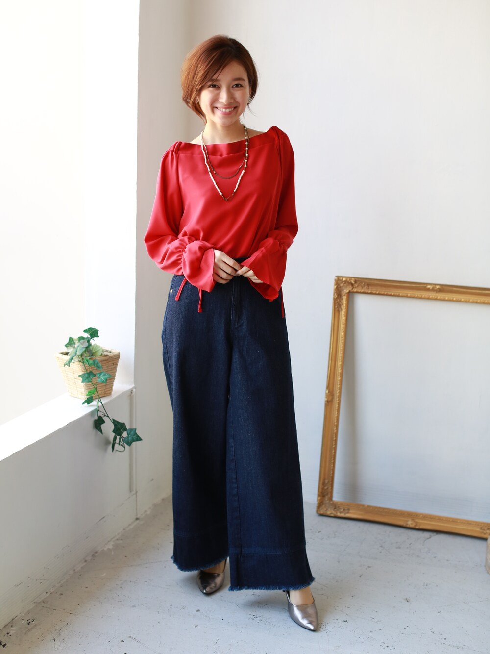 レッド系のシャツ/ブラウス、ブルー系のデニムパンツを着用したレディースの春コーディネートの1枚目の写真